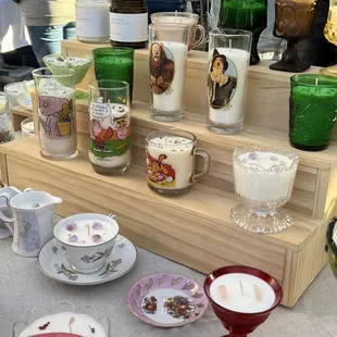 a variety of candles and teacups