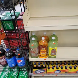 a shelf of sodas and soft drinks