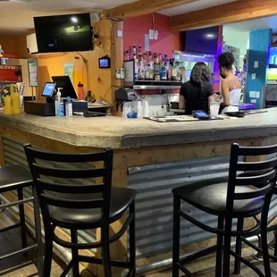 ows a woman sitting at the bar
