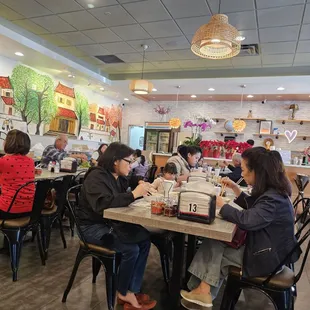 a group of people eating at a restaurant