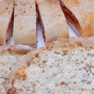 a close up of a sliced pizza