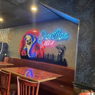Inside, across from the bar.