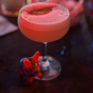 a pink drink in a coupe glass