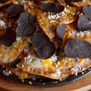 Truffle Nachos (white cheddar sauce, black truffles, chives)