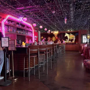 a woman standing at a bar