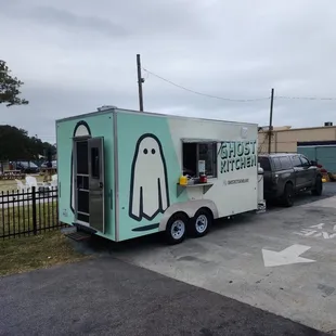 a ghost food truck parked in a parking lot