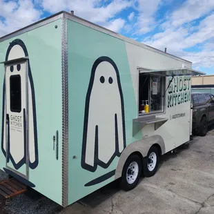 a ghost face on the side of a food truck