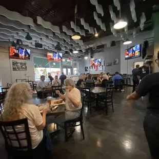 people sitting at tables in a restaurant
