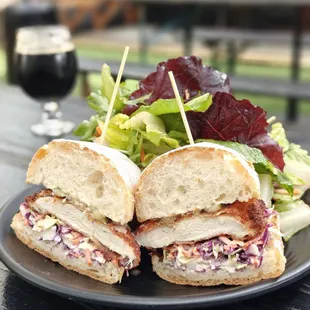 Yummy fried chicken sando with cole slaw, choice of salad or fries, $13 on 3/6/24, with three types of hot sauce à volonté.