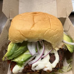 Delicious veggie burger with queso Oaxaca cheese, avocado, onion, lettuce and tomato!