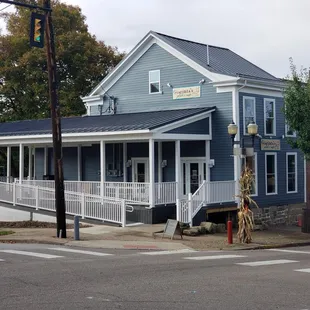 a blue building with a white porch