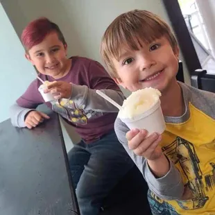 two young boys eating ice cream