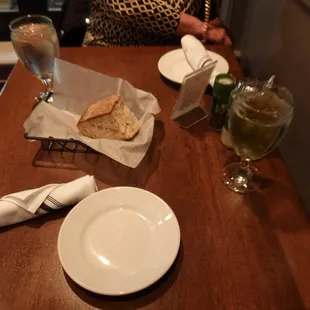 a wooden table with plates and napkins