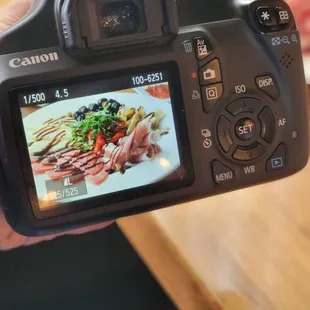 a person taking a picture of a plate of food