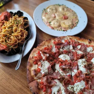 a pizza, pasta, and salad