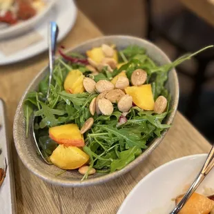 a bowl of salad and a plate of carrots