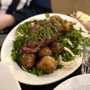 Bistecca, steak over arugula