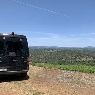 a van parked on the side of a dirt road