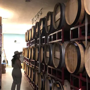 a woman standing in a wine cellar