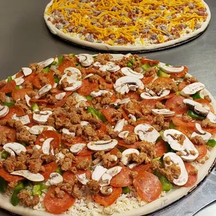 three pizzas on a table