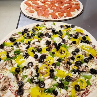 two pizzas on a table