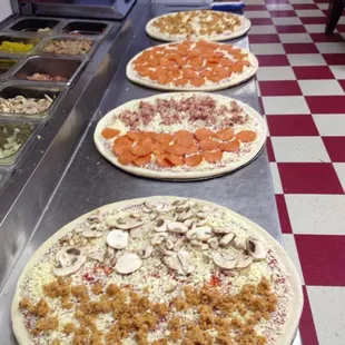 a row of pizzas