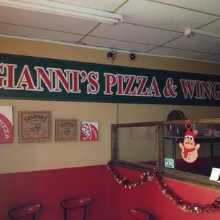 a sign for gianni&apos;s pizza and wings