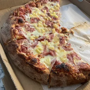 a half eaten pizza in a box