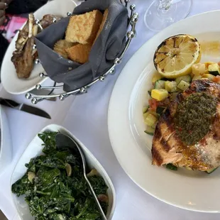 Food: Grilled salmon, sauteed spinach, mashed potatoes, and rack of lamb chops