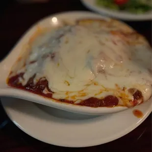 Lasagna - bigger than photo gives credit! Side salad behind, crisp and fresh.