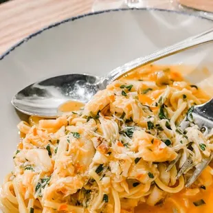 a plate of pasta and a glass of water