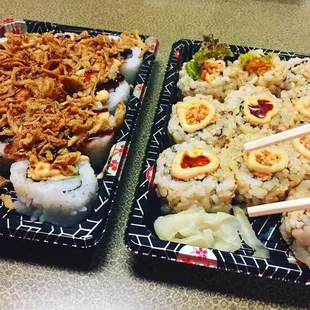 two plates of sushi with chopsticks