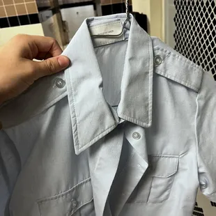 Wrinkled/messed up short sleeve light blue shirt