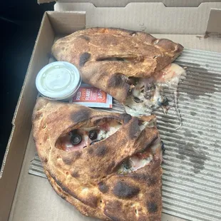 Calzone with ham pineapple and black olives.