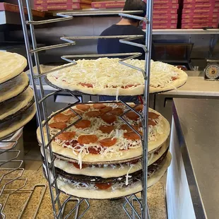 stacked pizzas in a kitchen