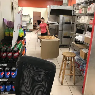 a woman standing in a commercial kitchen