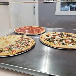 a variety of pizzas on display