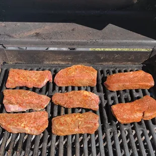 meat being cooked on a grill
