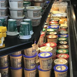 a display of cheeses and yogurts
