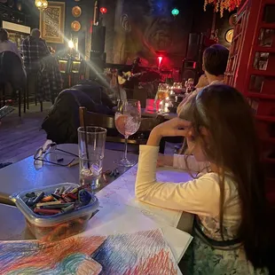 Us coloring- with the owner playing guitar in the far back. You can kinda see the gorgeous lights hanging from the ceiling too!