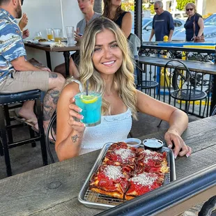 From the D Pizza  (pepperoni pizza)  Detroit AF cocktail  Enjoyed on the patio  Detroit style pizza Signature Cocktails