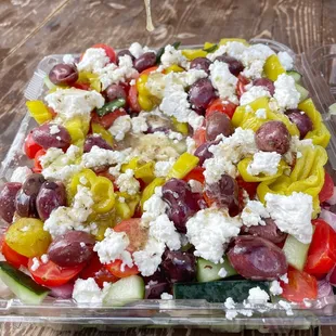 Opa! Greek Salad with kalamata olives,  Bulgarian feta cheese, tomato, red onion, cucumber, pepperoncinis, and Greek salad dressing.