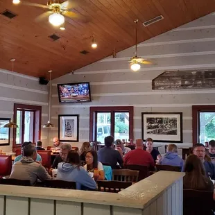 ows a large group of people sitting at tables