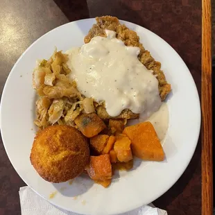 Chicken fried steak with cabbage, yams and a cornbread roll