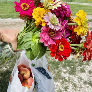 a person holding a bunch of flowers