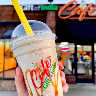 a hand holding a cup of coffee