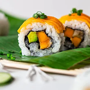 a sushi roll with mango and cucumber