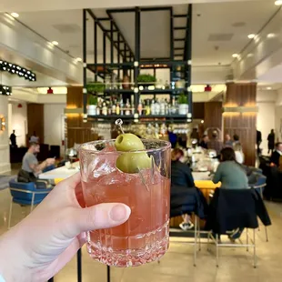 a person holding a drink