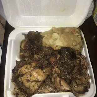 Jerk chicken (with stew chicken gravy), cabbage and rice &amp; peas... very spicy!! But not bad.