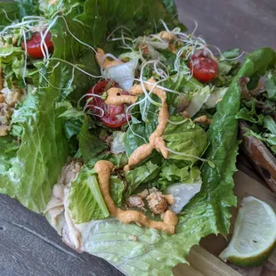 Soulful Tacos {spicy hummus &amp; chickpeas wrapped in romaine lettuce, topped with mixed greens, cherry tomatoes, sprouts, cheezy sauce}